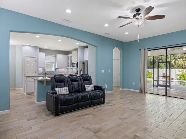 a kitchen with stainless steel appliances granite countertop a sink refrigerator and cabinets