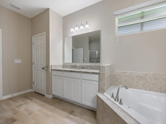 a bedroom with a bed and a flat tv screen