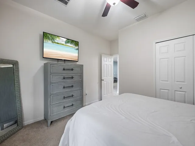 a bedroom with a large bed and a flat screen tv