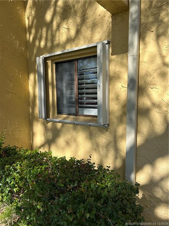 5355 Southeast Miles Grant Road, Unit E114 Stuart, FL 34997 - Photo 14 of 15 Accordian shutters