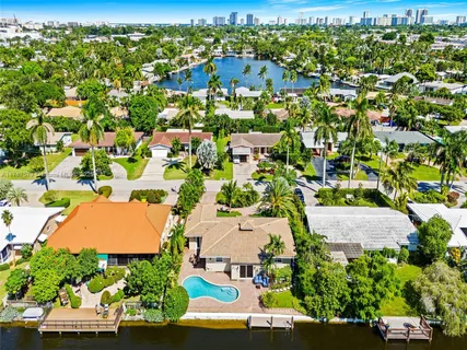 an aerial view of residential houses with outdoor space and street view