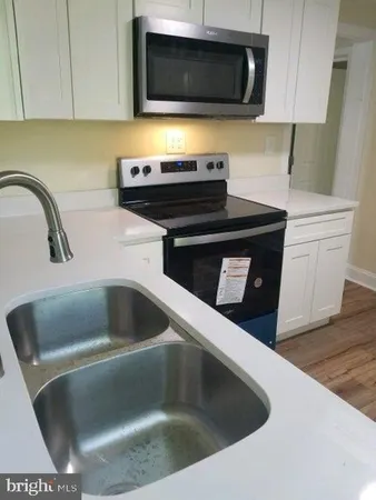 a kitchen with a stove and a microwave