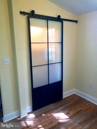 a view of front door with wooden floor