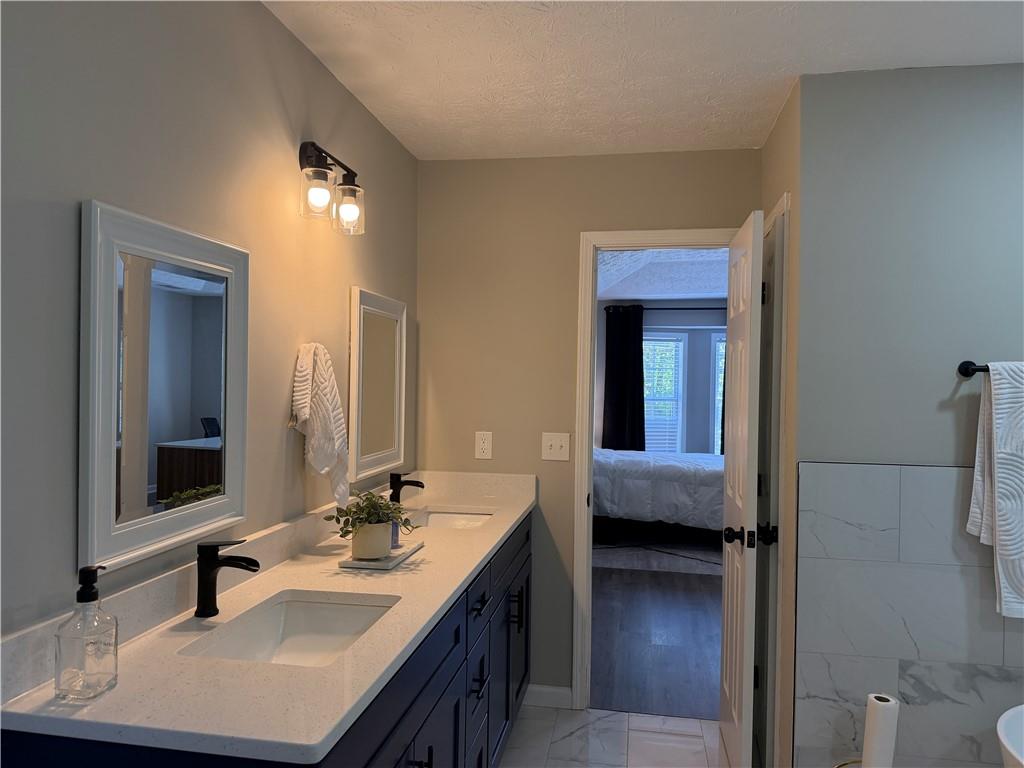 934 Bay Ridge Drive Lawrenceville, GA 30045 - Photo 58 of 78 a en suite bathroom with a sink double vanity and a mirror