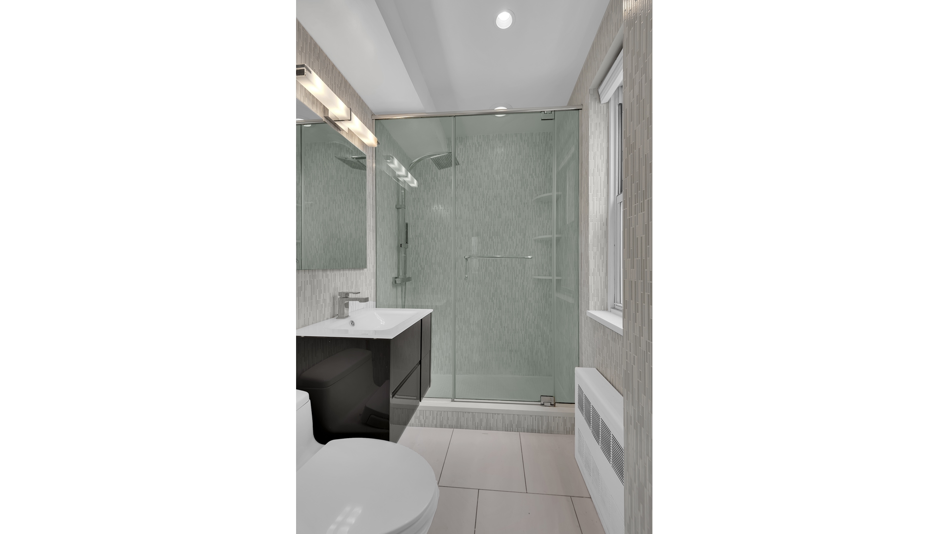233 East 69th Street, Unit 3L Manhattan, NY 10021 - Photo 4 of 9 a bathroom with a toilet a sink and mirror
