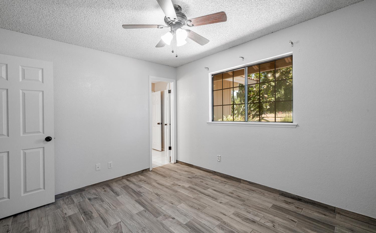 12502 Road 37 1/2 Madera, CA 93636 - Photo 22 of 79 a view of an empty room with a window