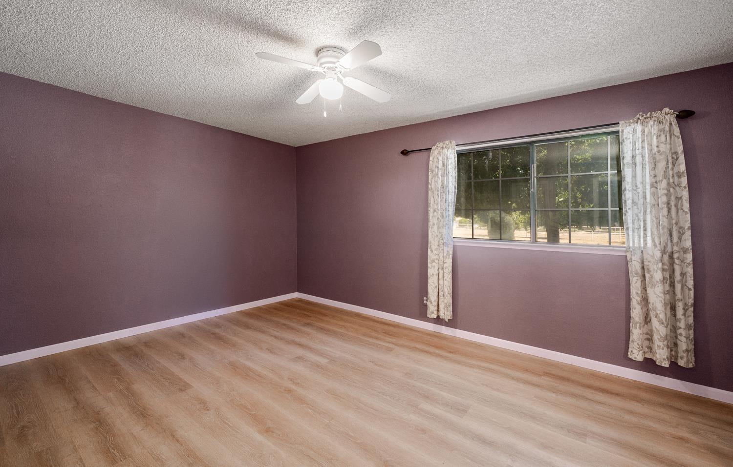 12502 Road 37 1/2 Madera, CA 93636 - Photo 24 of 79 an empty room with windows and closet