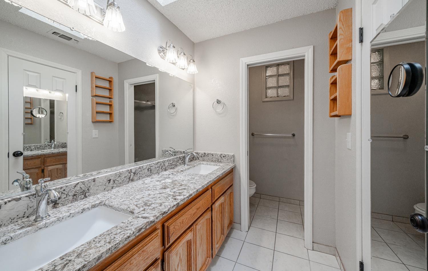 12502 Road 37 1/2 Madera, CA 93636 - Photo 27 of 79 a bathroom with a granite countertop sink and a mirror