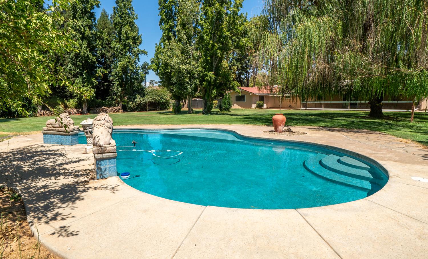12502 Road 37 1/2 Madera, CA 93636 - Photo 45 of 79 a view of a swimming pool with a sitting area