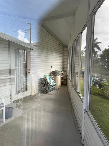 a view of a balcony with furniture
