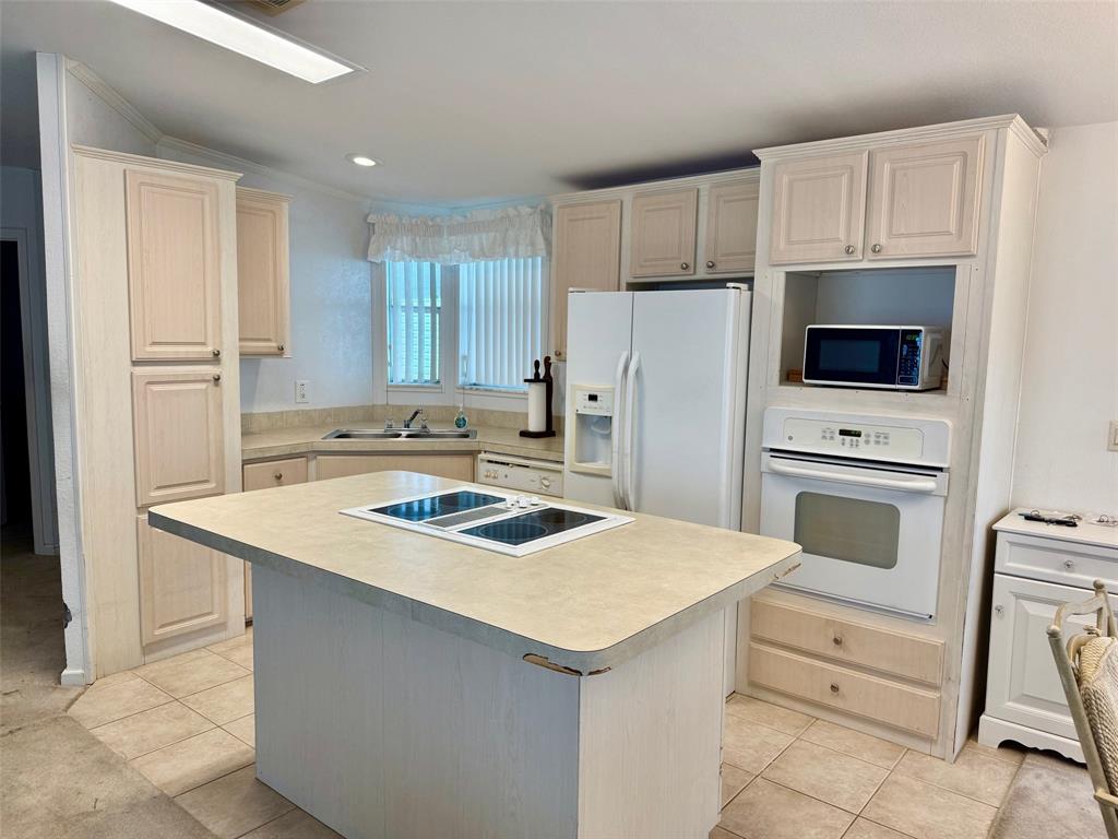 2080 Southwest 85th Avenue Davie, FL 33324 - Photo 2 of 13 a kitchen with white cabinets and white appliances