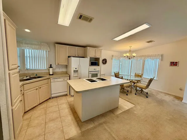 a kitchen with a sink a counter top space and appliances