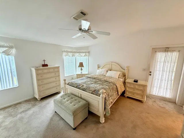a bedroom with a bed a couch and dresser