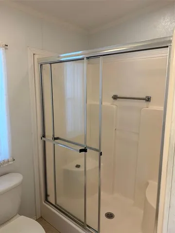 a bathroom with a glass shower door
