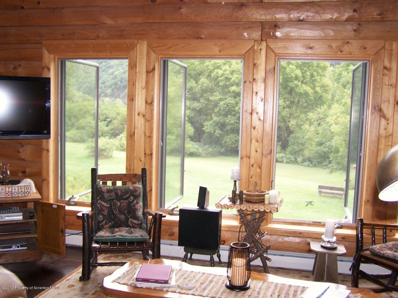 98 Detrick Road Sugar Run, PA 18846 - Photo 12 of 48 a living room with furniture and floor to ceiling windows