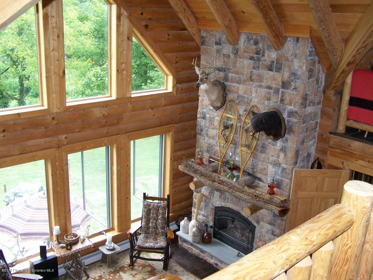 98 Detrick Road Sugar Run, PA 18846 - Photo 10 of 48 a living room with fireplace furniture and a floor to ceiling window