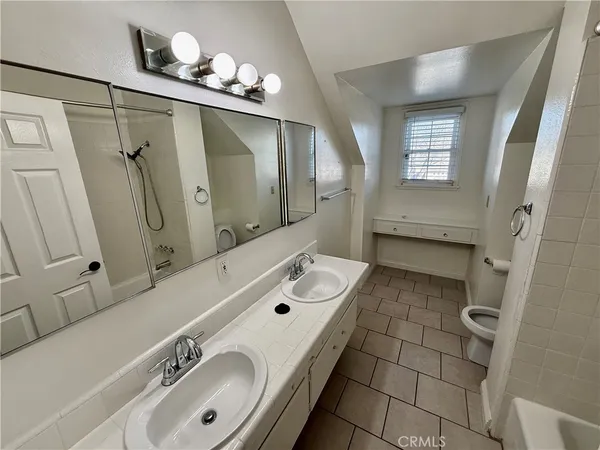 a bathroom with a double vanity sink mirror and shower