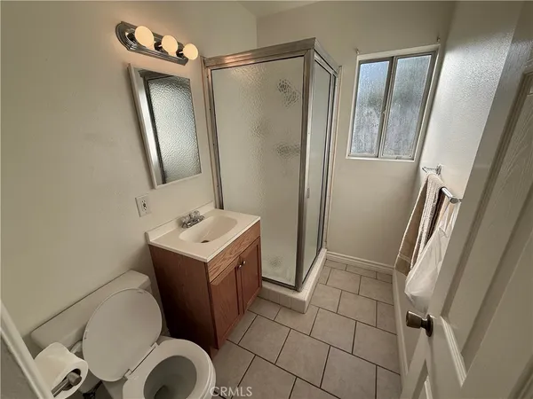 a bathroom with a sink mirror vanity and toilet