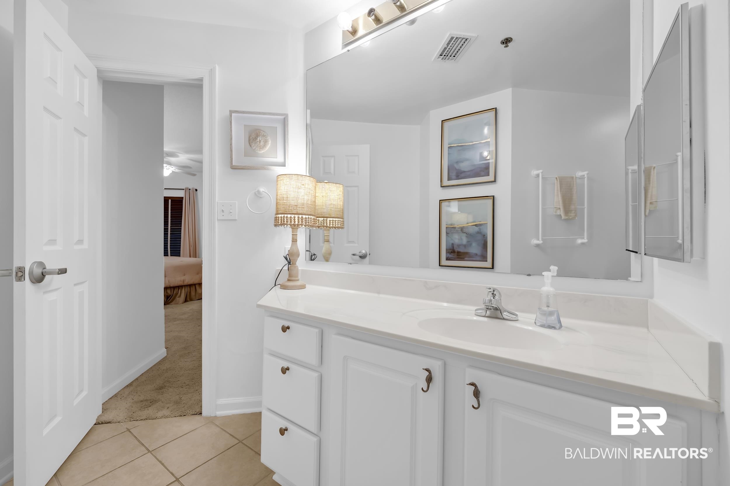 27282 Canal Road, Unit 104 Orange Beach, AL 36561 - Photo 51 of 79 Bathroom with vanity, light tile patterned floors, light carpet, and ensuite bathroom