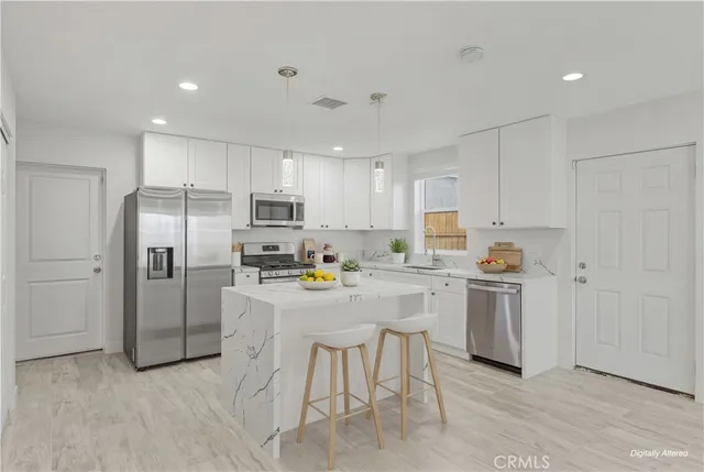 a kitchen with cabinets and stainless steel appliances