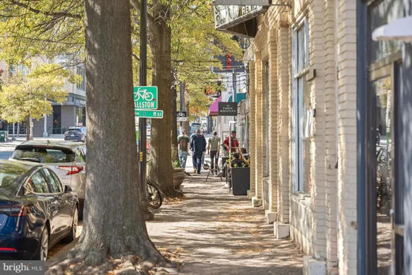 a view of a store with a lot of cars parked on road