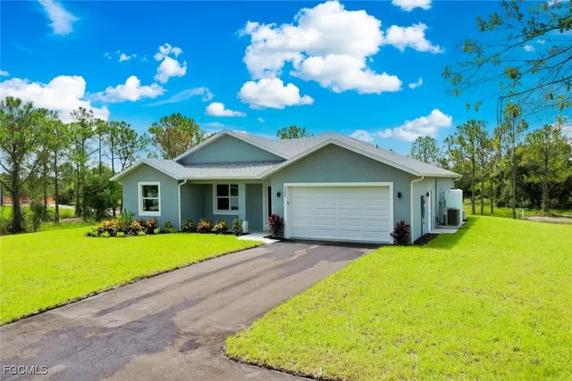 a front view of house with yard and green space