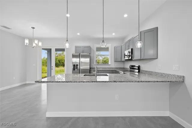 a kitchen with a stove a sink and a microwave