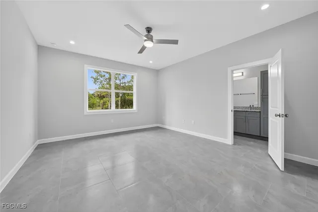 an empty room with closet and ceiling fan