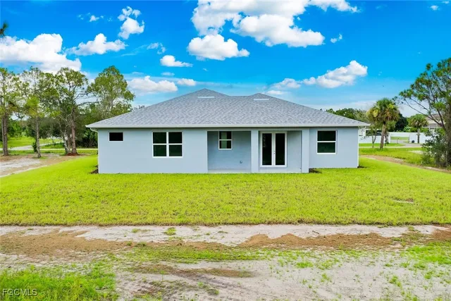 a view of a swimming pool with an outdoor seating and a yard