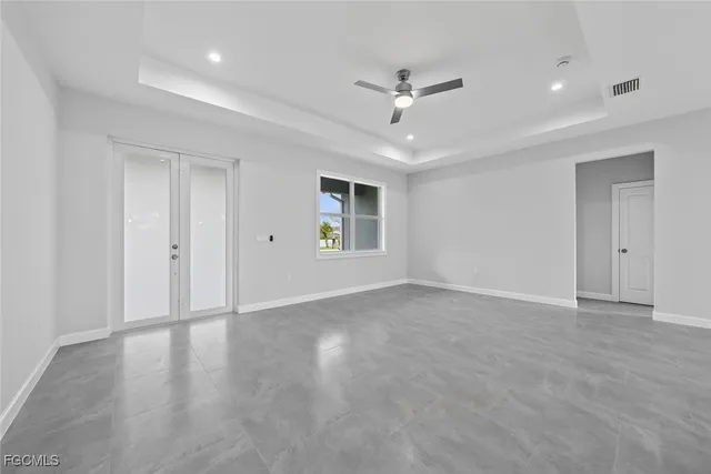 a view of a kitchen with kitchen island a sink stainless steel appliances and cabinets
