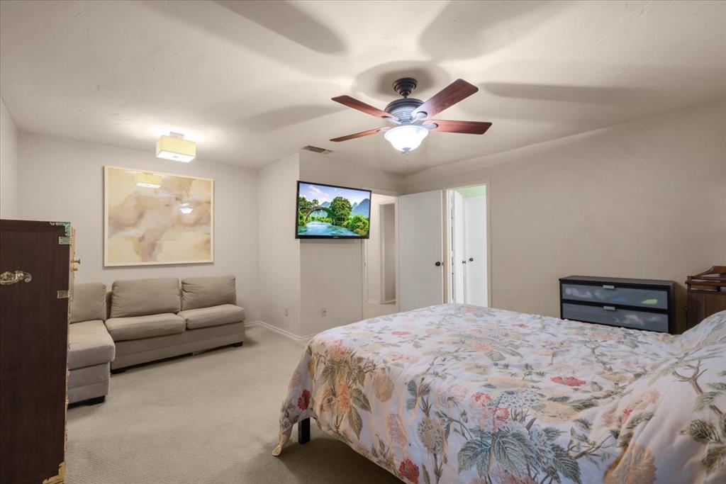 220 Annetta Road Willow Park, TX 76087 - Photo 12 of 40 a bedroom with a large bed and furniture