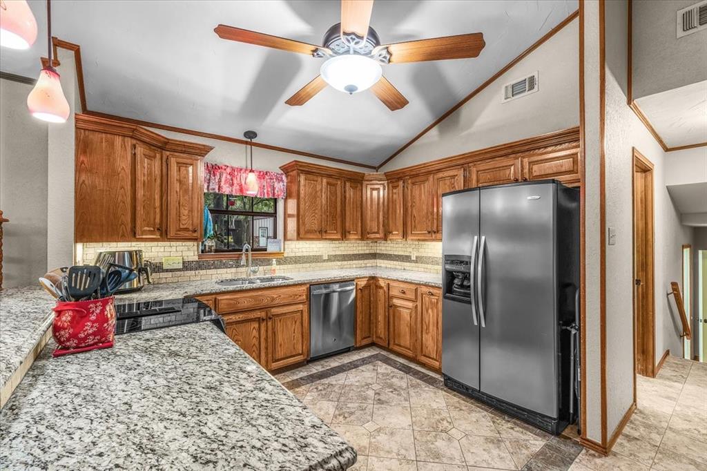 220 Annetta Road Willow Park, TX 76087 - Photo 22 of 40 a kitchen with stainless steel appliances granite countertop a sink stove and refrigerator
