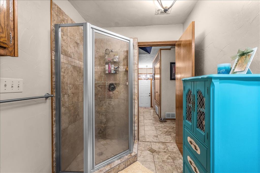 220 Annetta Road Willow Park, TX 76087 - Photo 27 of 40 a bathroom with a glass door shower and a sink