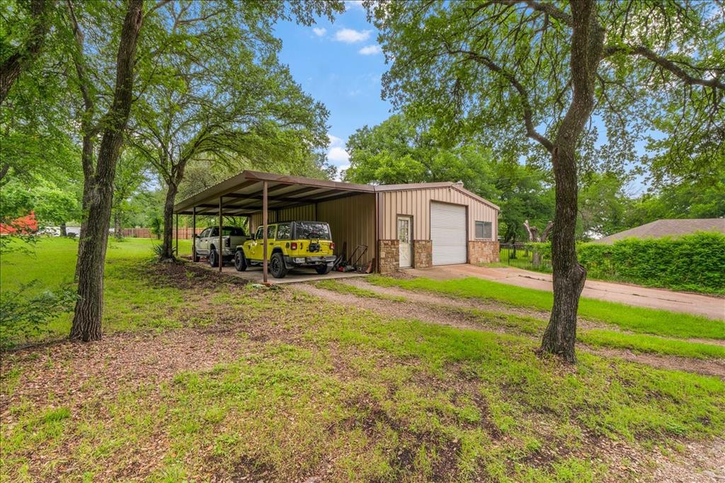 220 Annetta Road Willow Park, TX 76087 - Photo 32 of 40 a view of a house with backyard and a tree