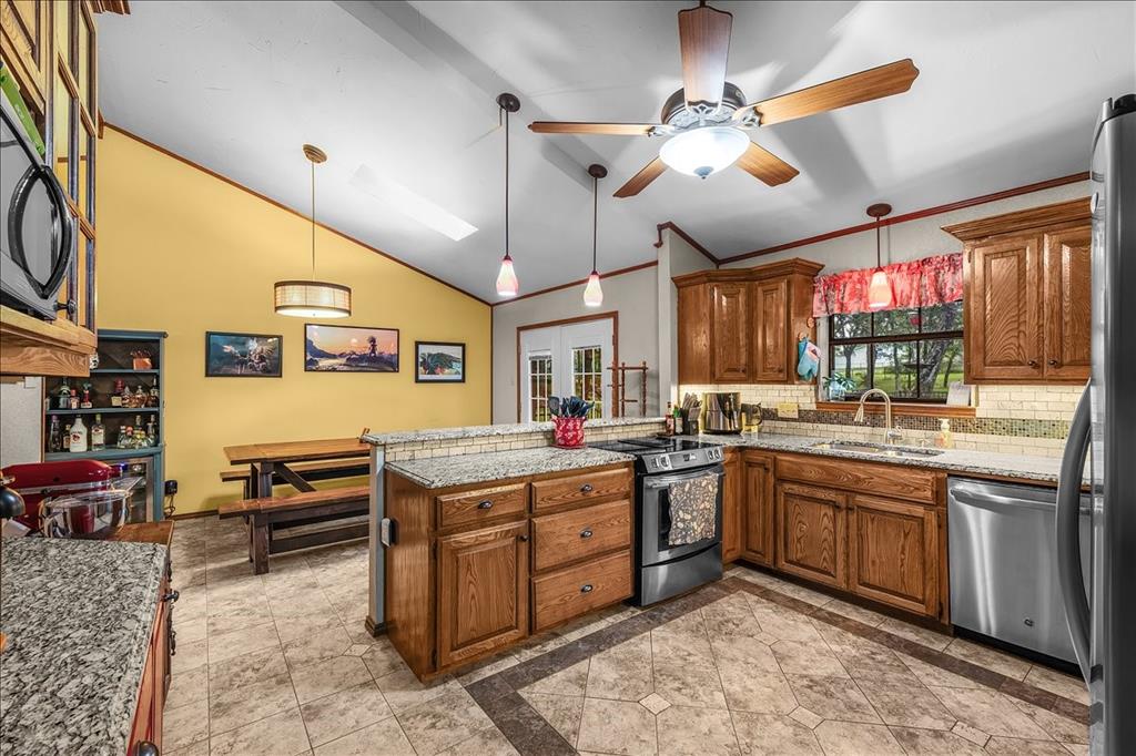 220 Annetta Road Willow Park, TX 76087 - Photo 9 of 40 a kitchen with lots of counter top space appliances and a window