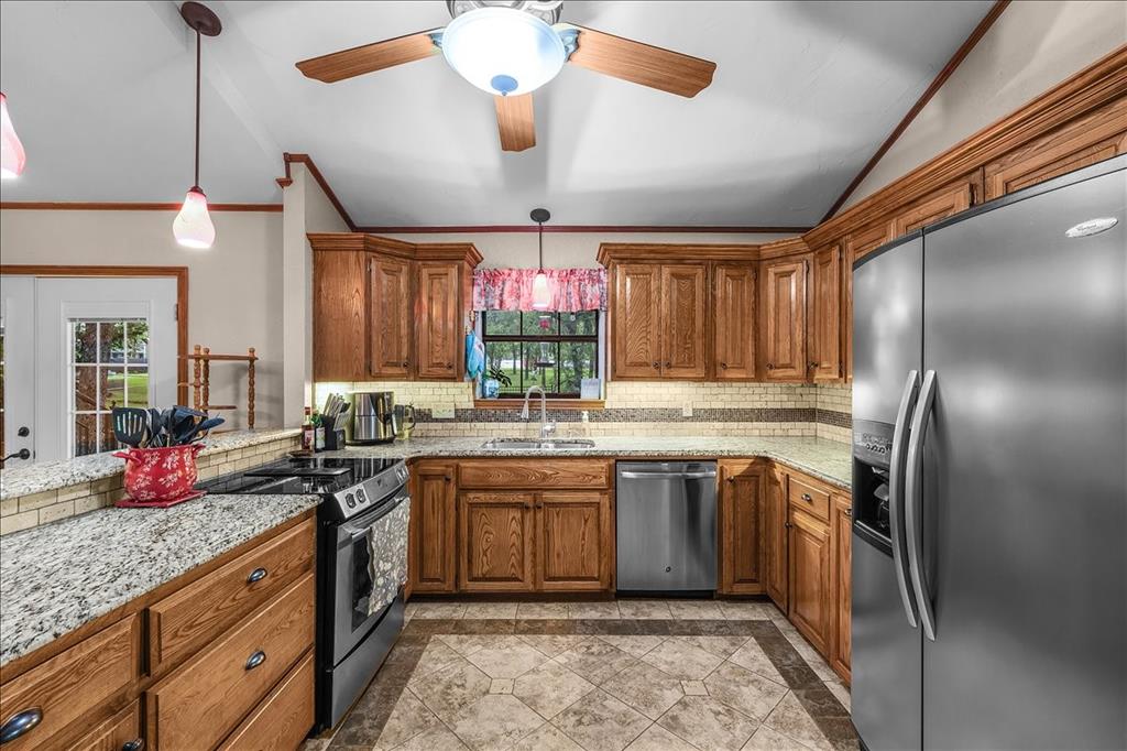 220 Annetta Road Willow Park, TX 76087 - Photo 10 of 40 a kitchen with stainless steel appliances granite countertop a sink stove and refrigerator