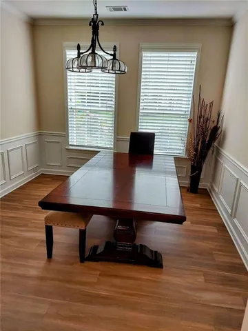 a view of a dining room with furniture and windows