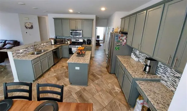 a kitchen with stainless steel appliances granite countertop a stove top oven