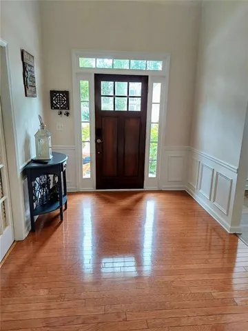 a view of staircase with white walls and wooden floor