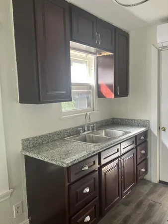 a kitchen with a sink stove and cabinets