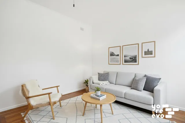 a living room with furniture and a window