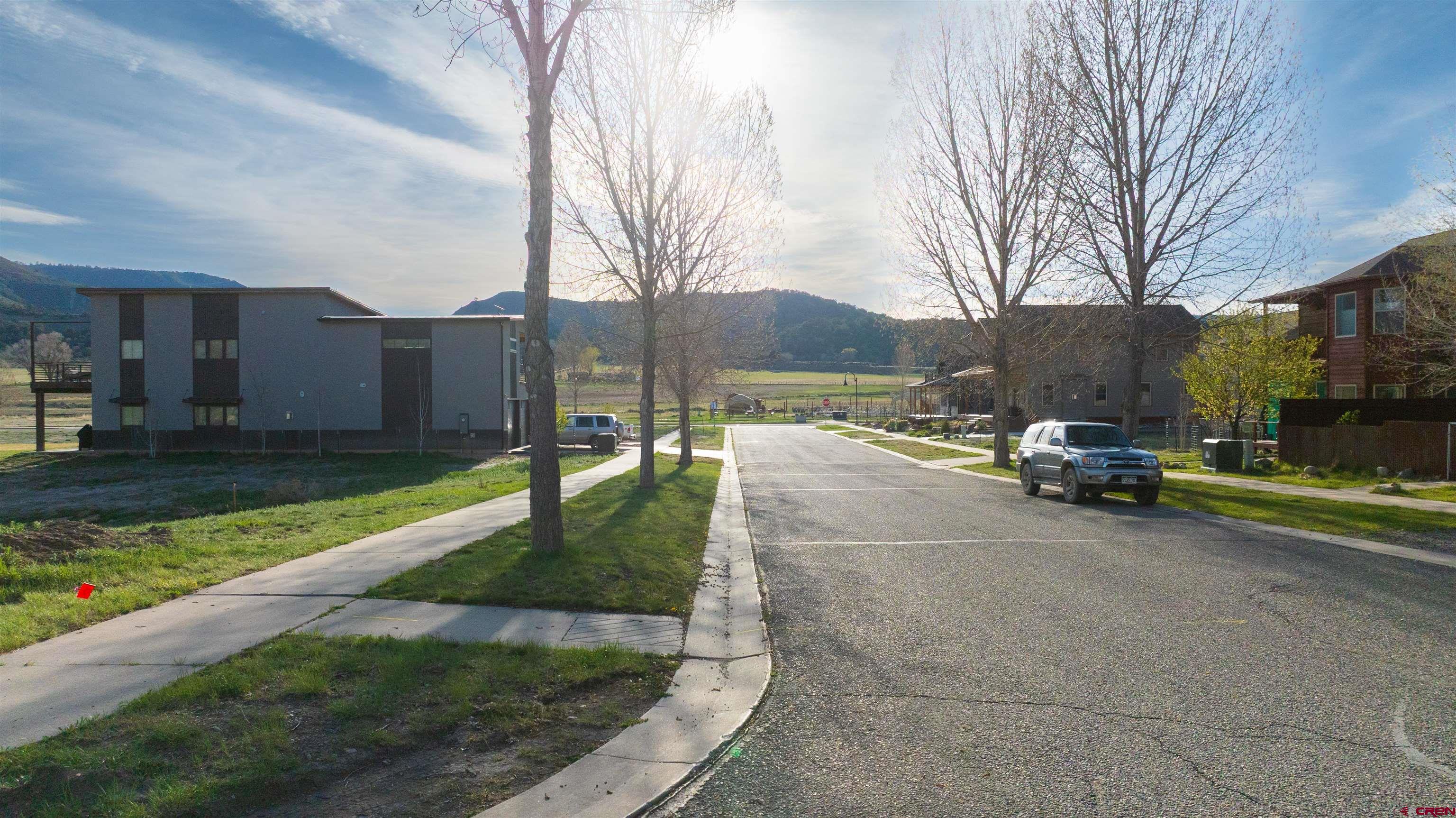 485 Kismet Street Ridgway, CO 81432 - Photo 15 of 23 a view of a street with a bench and trees