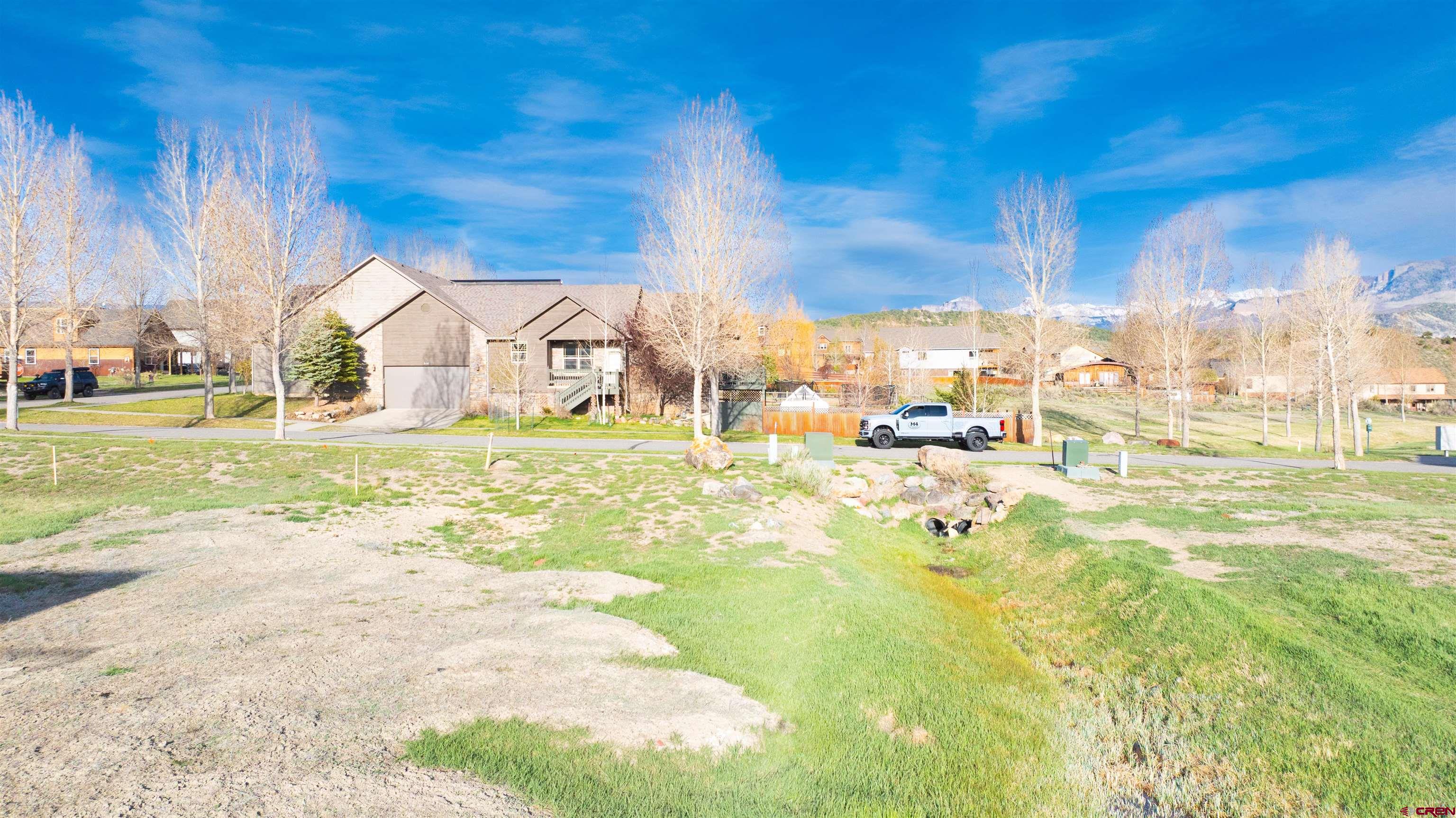 485 Kismet Street Ridgway, CO 81432 - Photo 19 of 23 a view of a house with a yard