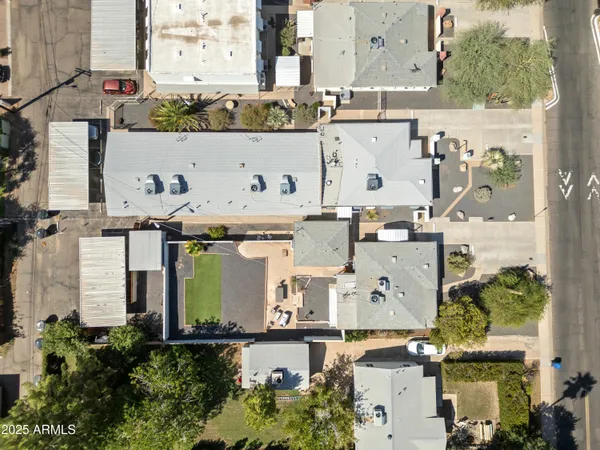 an aerial view of residential houses with outdoor space and parking
