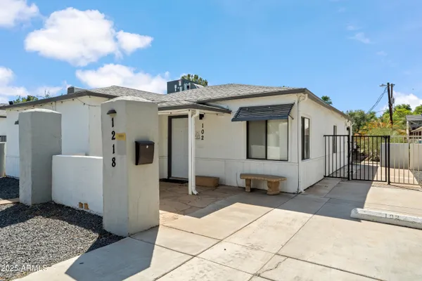 a view of a house with backyard and utility
