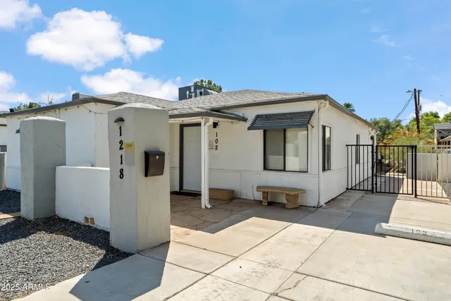 a view of a house with backyard and utility