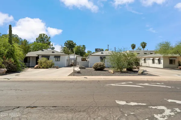 a front view of a house with a yard and a garage