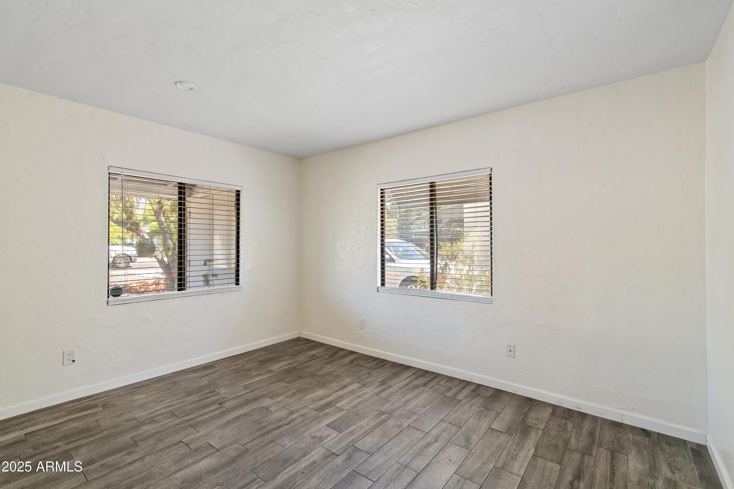 1218 South Farmer Avenue Tempe, AZ 85281 - Photo 19 of 47 an empty room with wooden floor and windows
