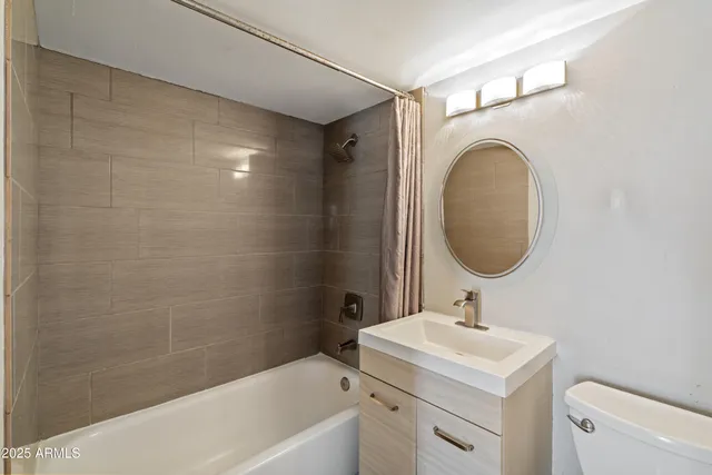 a bathroom with a sink a mirror toilet and bathtub