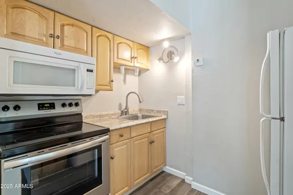 a kitchen with stainless steel appliances granite countertop a stove and a microwave